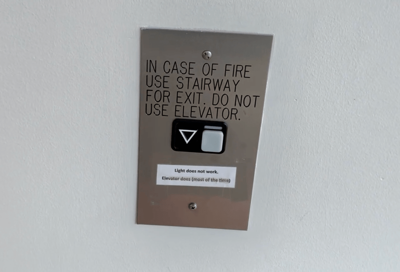 The exterior elevator button box reads "Light does not work. Elevator does (most of the time)."